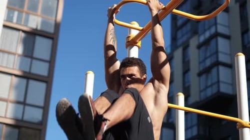 Young Muscular Man Has the Training Outdoors. Sport, Fitness, Street Workout Concept