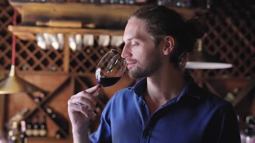 Wine Tasting. Man Smelling, Drinking Red Wine At Winery Cellar