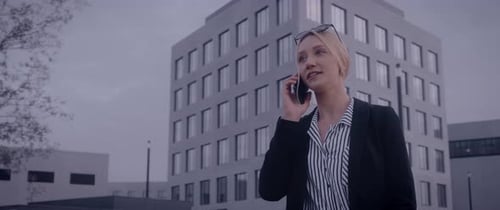 Professional Woman Talking on the Phone Near Building