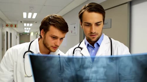 Doctors Analyzing X-Ray in Hospital Setting