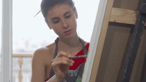 Sliding Shot of a Gorgeous Young Woman Drawing a Picture at Art Studio
