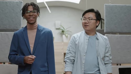 Colleagues Walking along Office and Talking