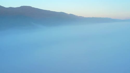 4K Drone Flying through the clouds at dusk or dawn. Aerial top cloudscape