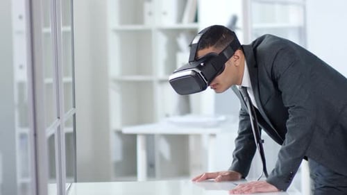 Man in Suit Using VR Headset in Office