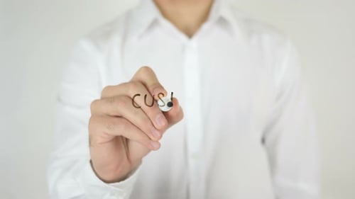 Man Writes Customer Experience on Glass