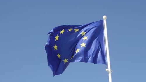 European Union Flag Waving Gently Against Blue Sky