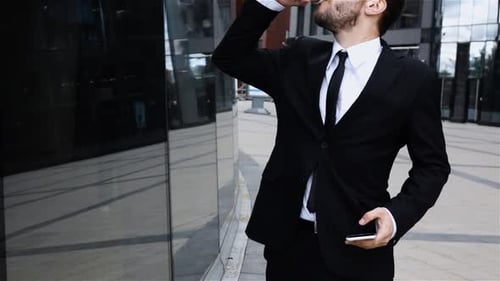 Boss Talking on Mobile Cell Phone in City. Coffee Break.