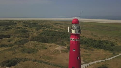 Close Up of Red Lighthouse on Beautiful Island with Beach in Summer, Netherlands