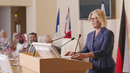 Female Politician Going at Tribune in Conference Hall