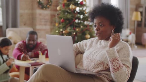 Woman Video Chatting at Home During Christmas