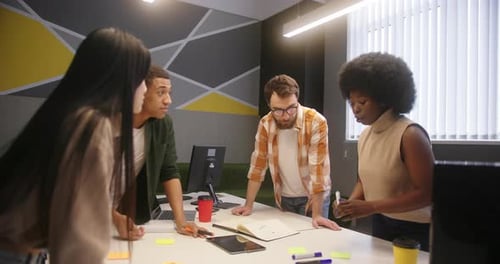 Colleagues Gather Together at Table to Discuss New Project