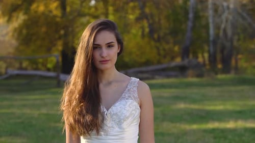 Beautiful Woman in a Dress Smiling Outdoors