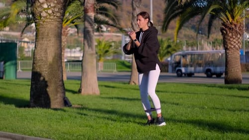 Young Woman Exercising Outdoors with Resistance Band