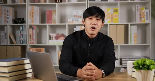 Young Adult Explaining Technical Subject At Desk