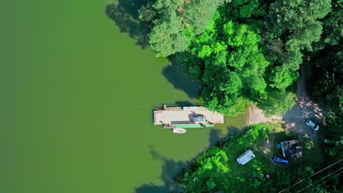 Aerial view of ferry boat transporting car across the river