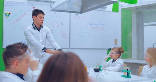 Teacher and Students Doing Science Experiment in School Classroom