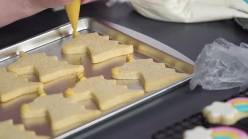 Step by step. Decorating unicorn sugar cookies with royal icing on baking sheet