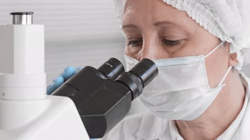 Scientist Working with Microscope in a Laboratory