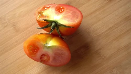Halved Tomato on a Wooden Cutting Board