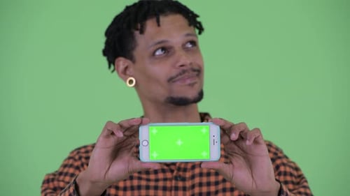Young Adult Holding Chroma Key Phone In Studio