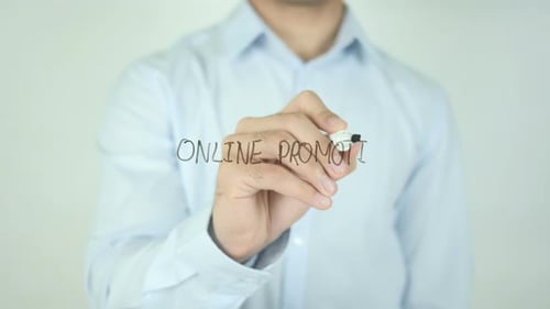 Man Writing Online Promotion on Clear Surface
