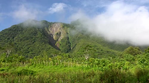 clouds passing over a dormant volcano in Asia 4k timelapse