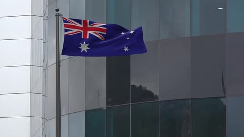 Waving Australian Flag on Modern Building