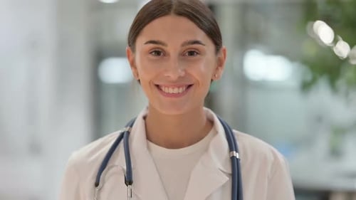 Smiling Woman Doctor Wearing Stethoscope and Lab Coat