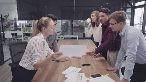 Team Discussing Data in Corporate Office