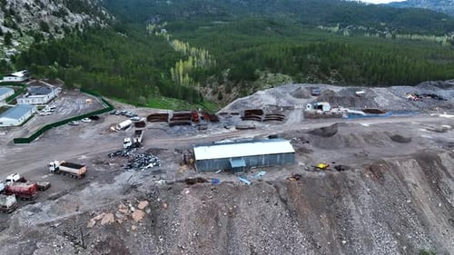 Heavy machinery drills tunnel through the mountain aerial view 4 K