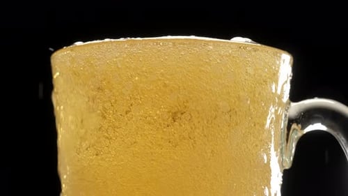 Light Beer being Poured into Glass Mug, Close Up