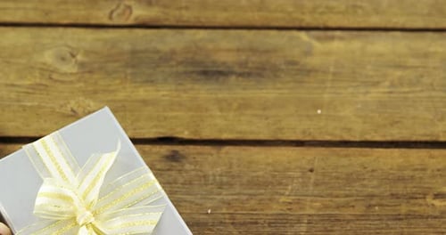 Silver Gift Box and Roses on Wooden Table