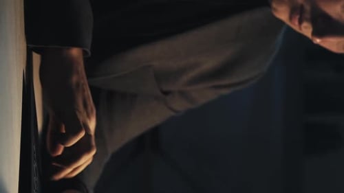 Adult Using Technology in Darkly Lit Room