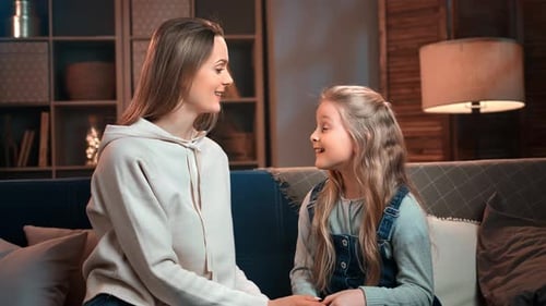 Loving Mother and Child Talking on Sofa