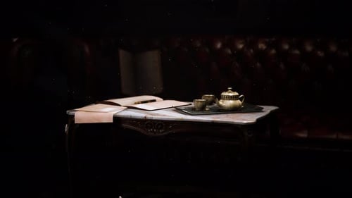 Elegant Dark Room with Antique Table, Open Book, and Tea Set