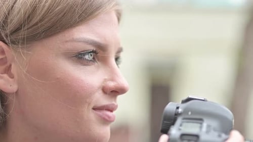 Woman Smiling and Taking Pictures with Camera