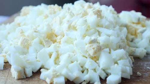 Close-up of Chopped Hard-boiled Eggs on Wooden Board