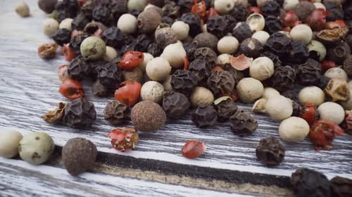 Variety of Flavorful Peppercorns on Wood Surface