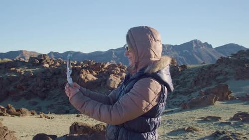 Woman Films Desert Landscape With Mobile Phone