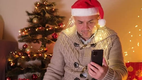 Man in Santa Hat Video Chatting With Gift