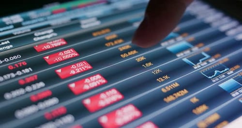 Use of tablet computer with showing stock market data at night