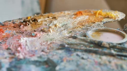 Motion Over Palette with Oil Paints with Brushes and Spatula