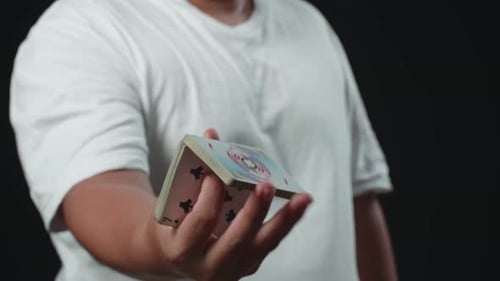 Hands Cardistry Shuffle Playing Cards on Black Backdrop