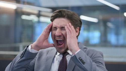 Stressed Businessman Screaming in an Office Environment