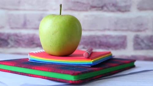 Black To School Concept with Apple on Notepad on Table.