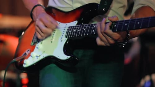 Male Musician Plays Bass Guitar at a Rock Concert.