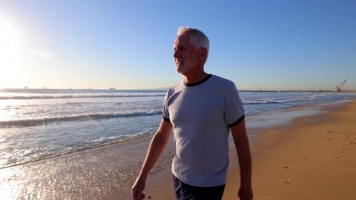 Hombre mayor haciendo ejercicio en la playa
