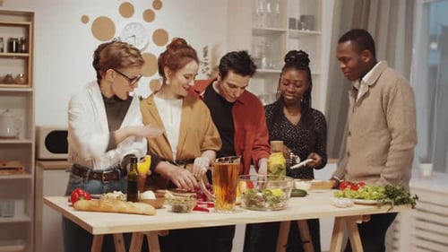 Friends and Family Prepare Food Together in Kitchen