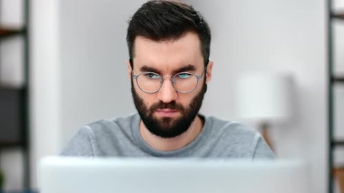 Confident Business Man Working Use Laptop Browsing Internet Searching Information at Home Office
