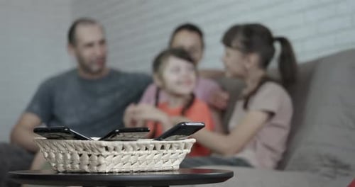 Family Together, Phones Away in Basket, at Home